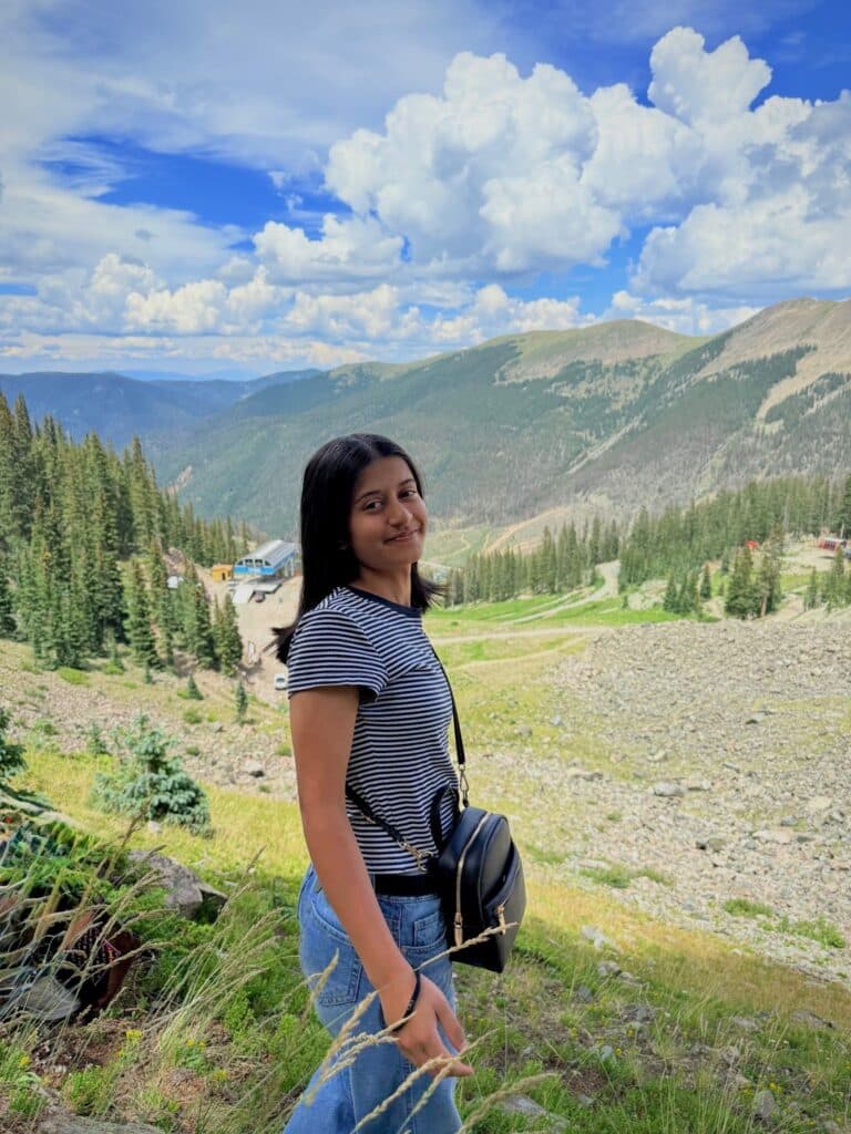 Eshwa, an ASRF student, standing on a mountain overlook